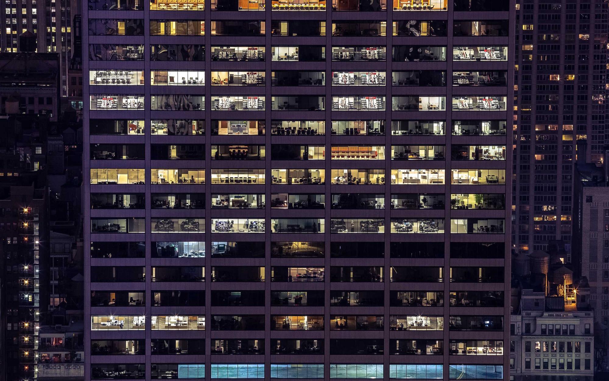 High-rise facade at night, a grid of lit windows