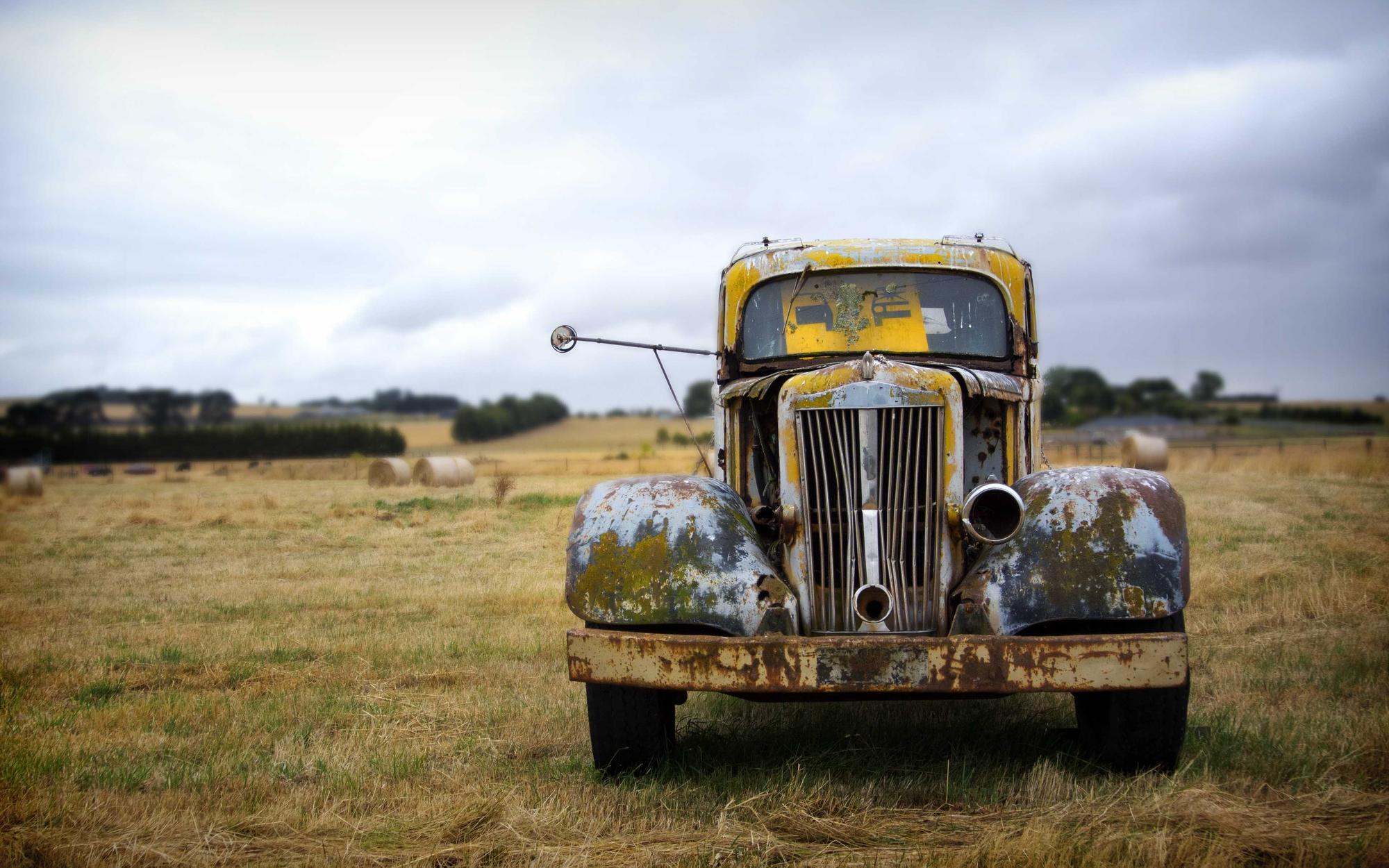 Weathered vintage truck standing in an open field