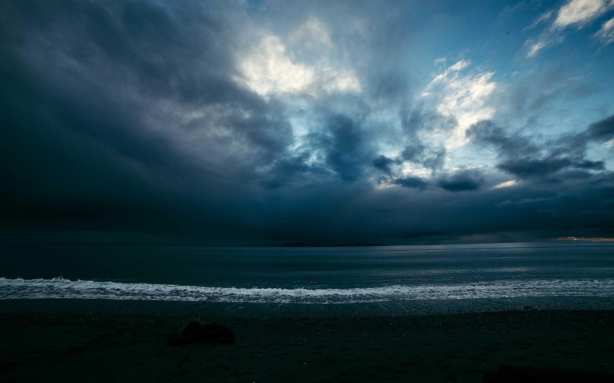 Storm light breaking over open water